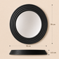 Black round wall mirror with a thick concentric-rimmed frame, shown with dimension callouts (78 cm diameter and 6.5 cm depth) on a beige background, plus feature icons below.
